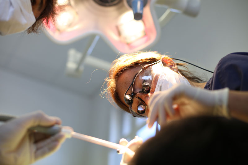 dentist performing gum recession treatment procedure