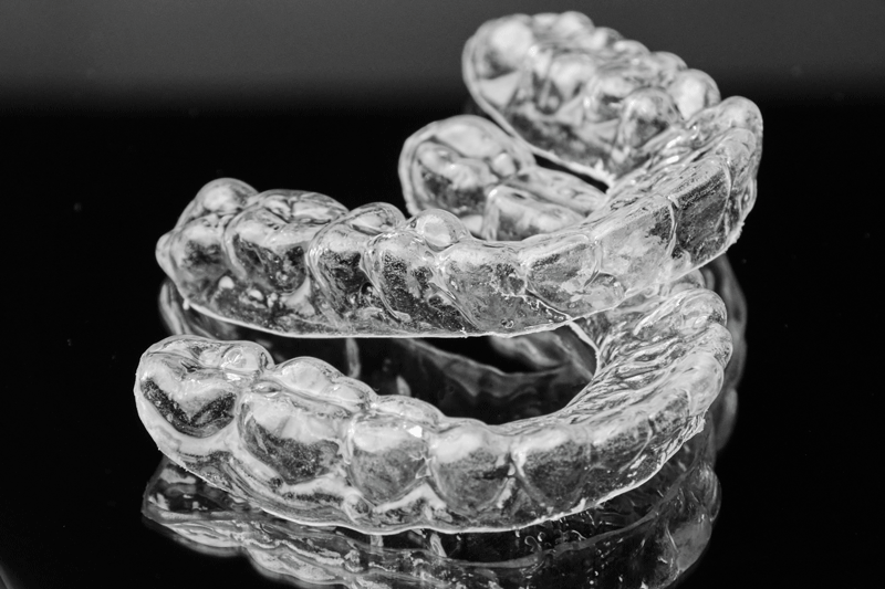 Invisible transparent dental removable braces on the black background.